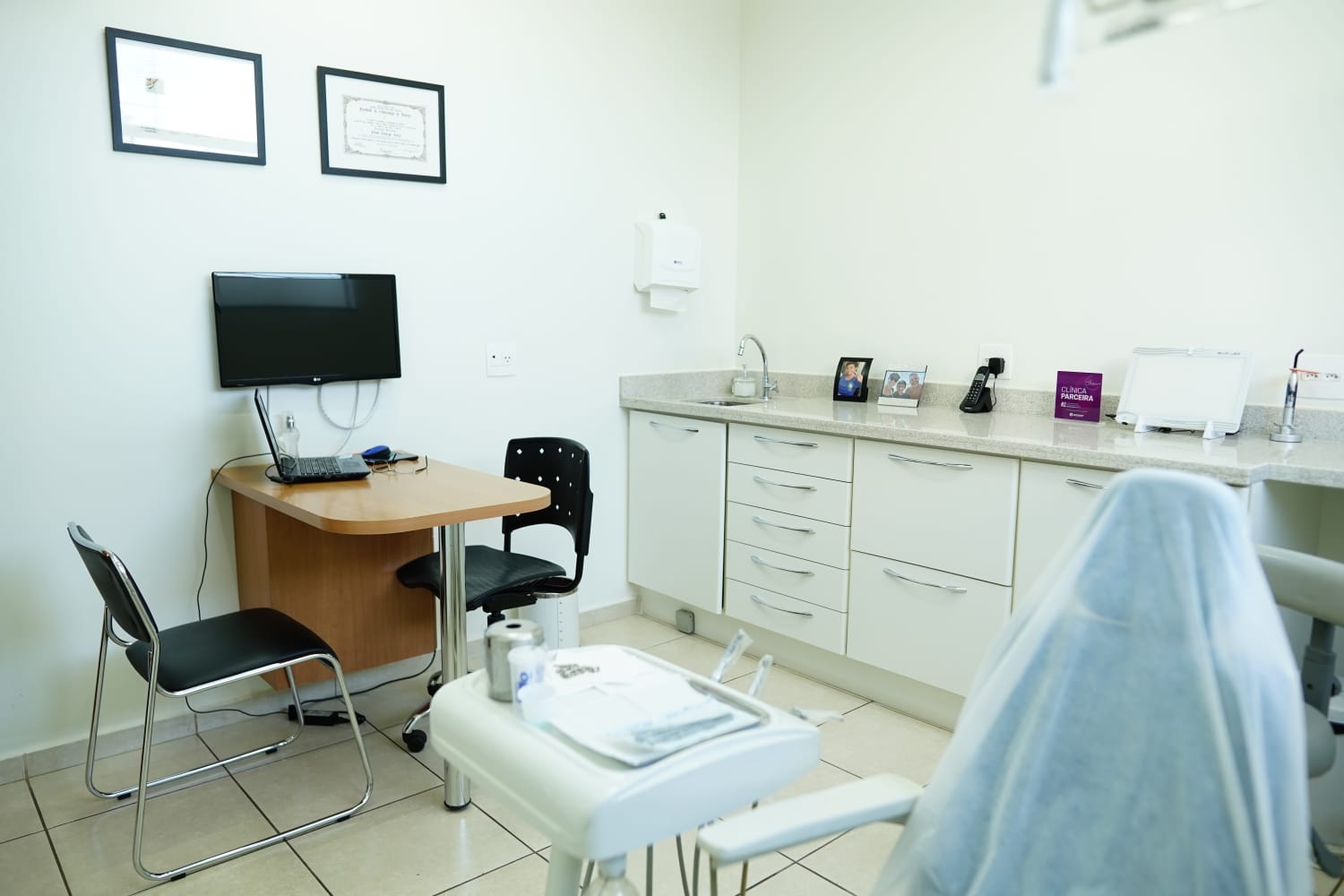 Consultório odontológico equipado com monitor e equipamentos digitais